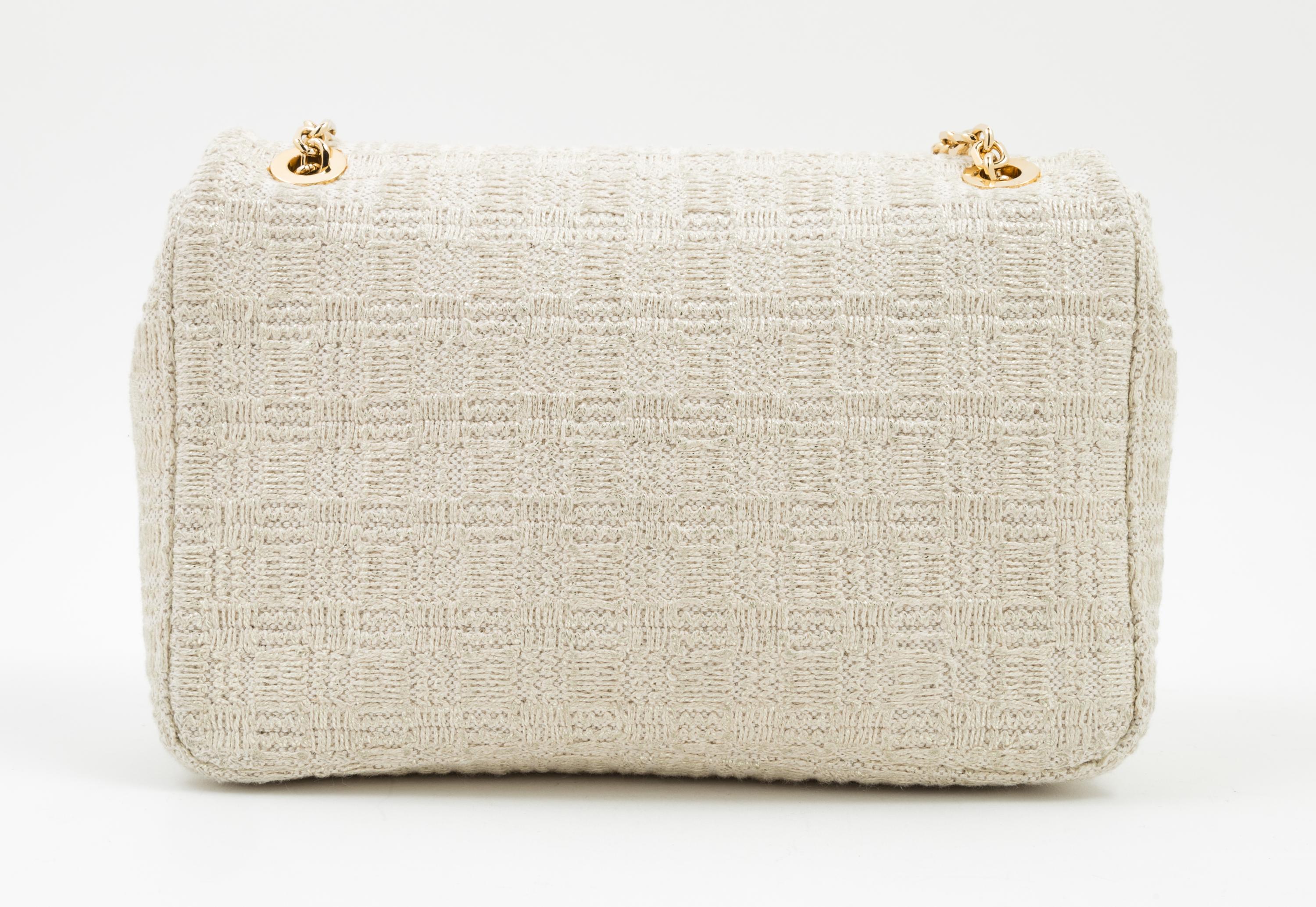A Judith Leiber Cream Tweed Flap Handbag, 9.5" x 6.5" x 2.5".