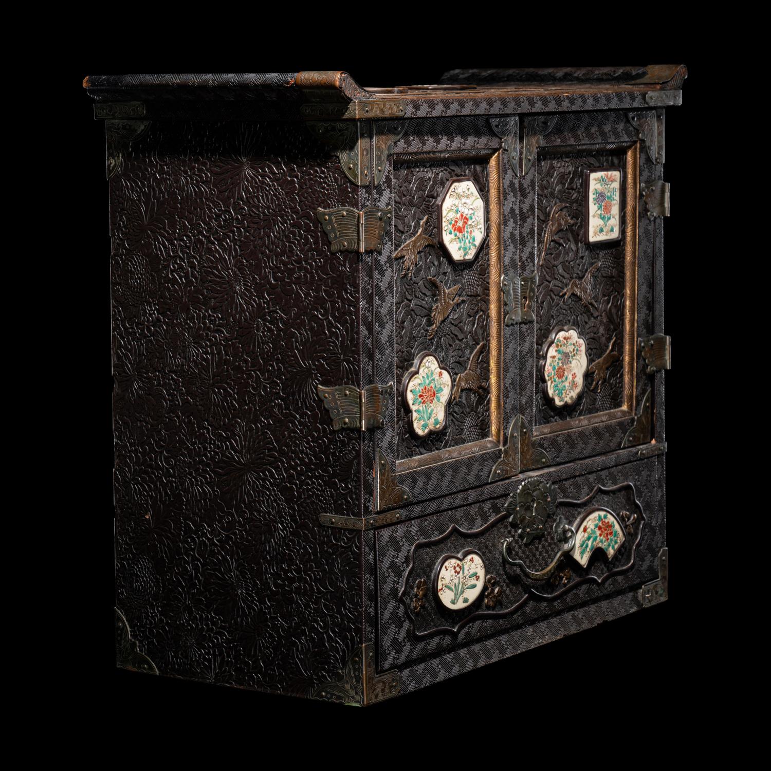 A Japanese Porcelain and Metal Inset Wood Chest