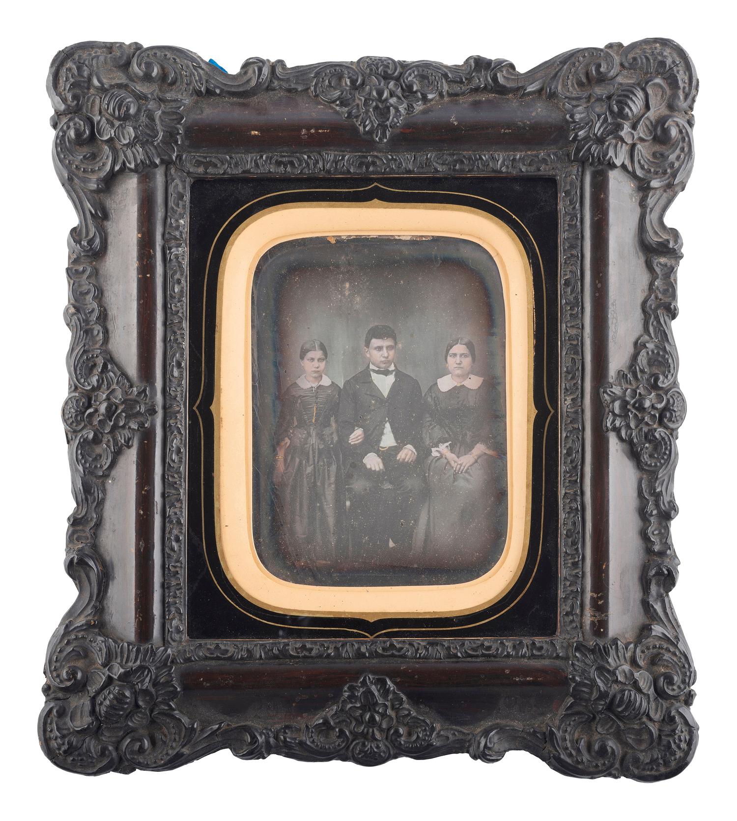 [EARLY PHOTOGRAPHY]. French half plate daguerreotype of a possible mixed race family housed in a wall frame. Lyon, n.d.