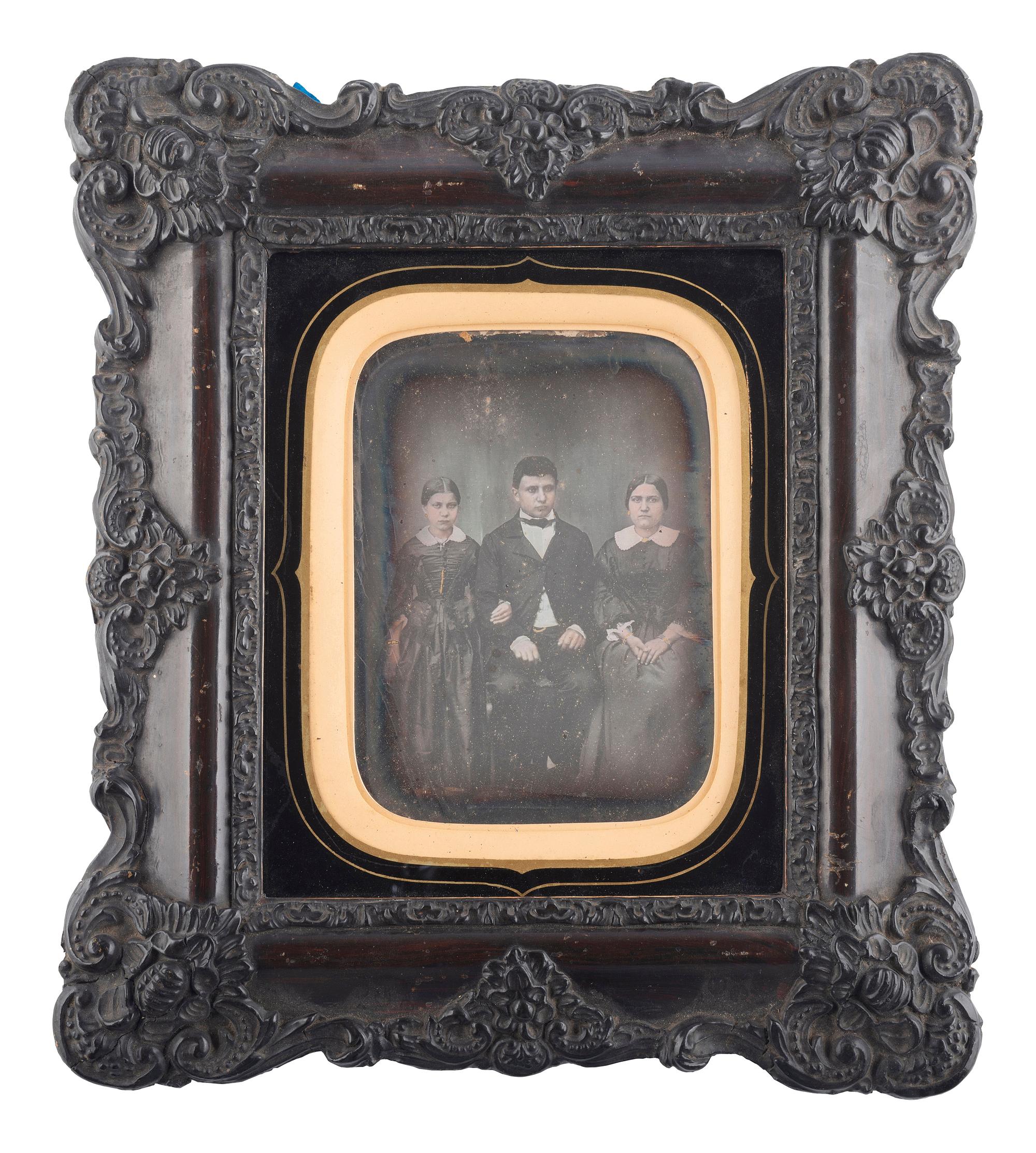 [EARLY PHOTOGRAPHY]. French half plate daguerreotype of a possible mixed race family housed in a wall frame. Lyon, n.d.