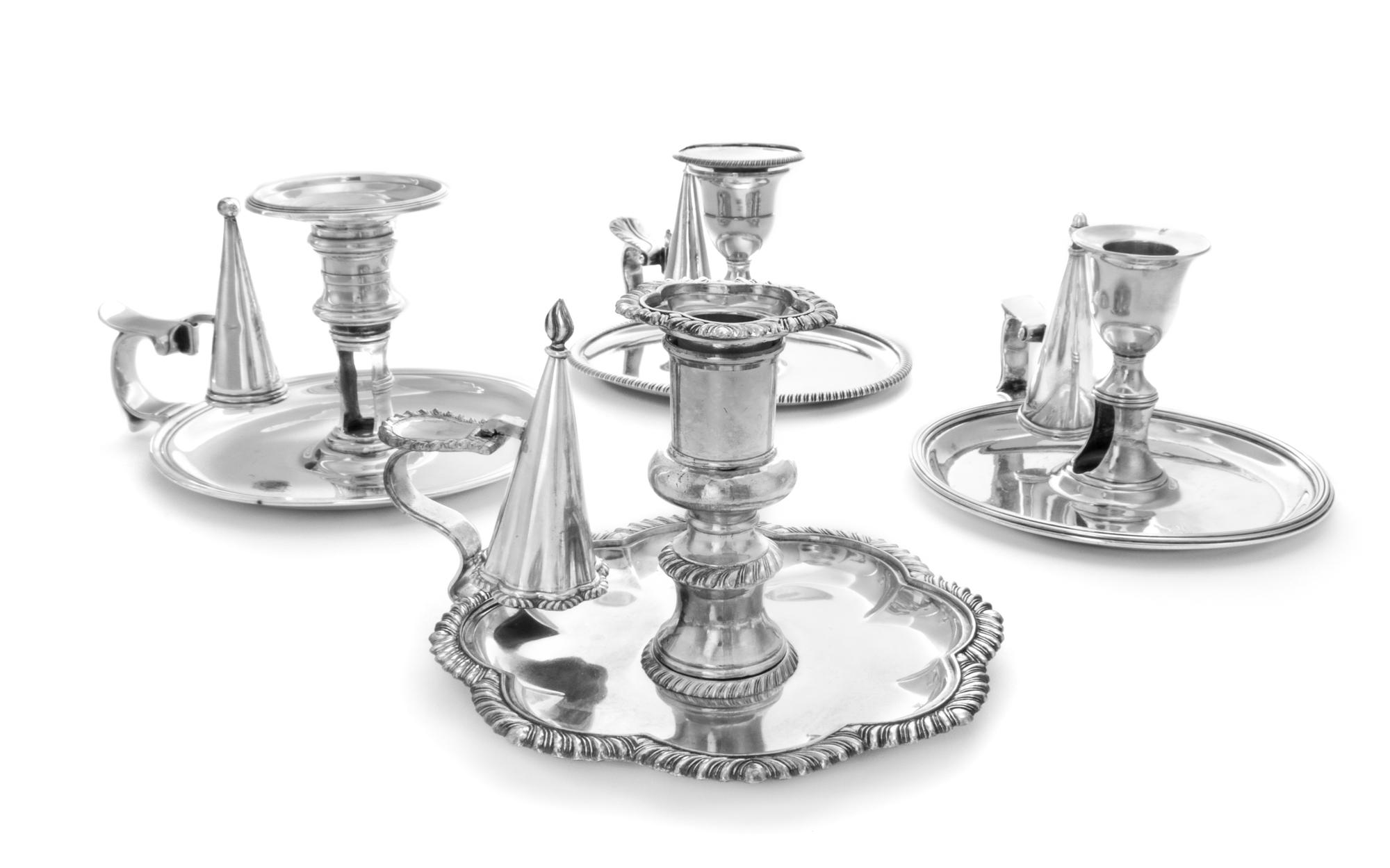 A Group of Silver Chambersticks, Various Makers, comprising a circular example engraved with a crest depicting a bird on rockery, Willi