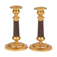 A Pair of Gilt Metal Mounted Candlesticks
