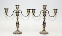 A Pair of American Silver Candlesticks, , having a central urn form cup and two conforming cups issuing S-scroll branches surmounting a