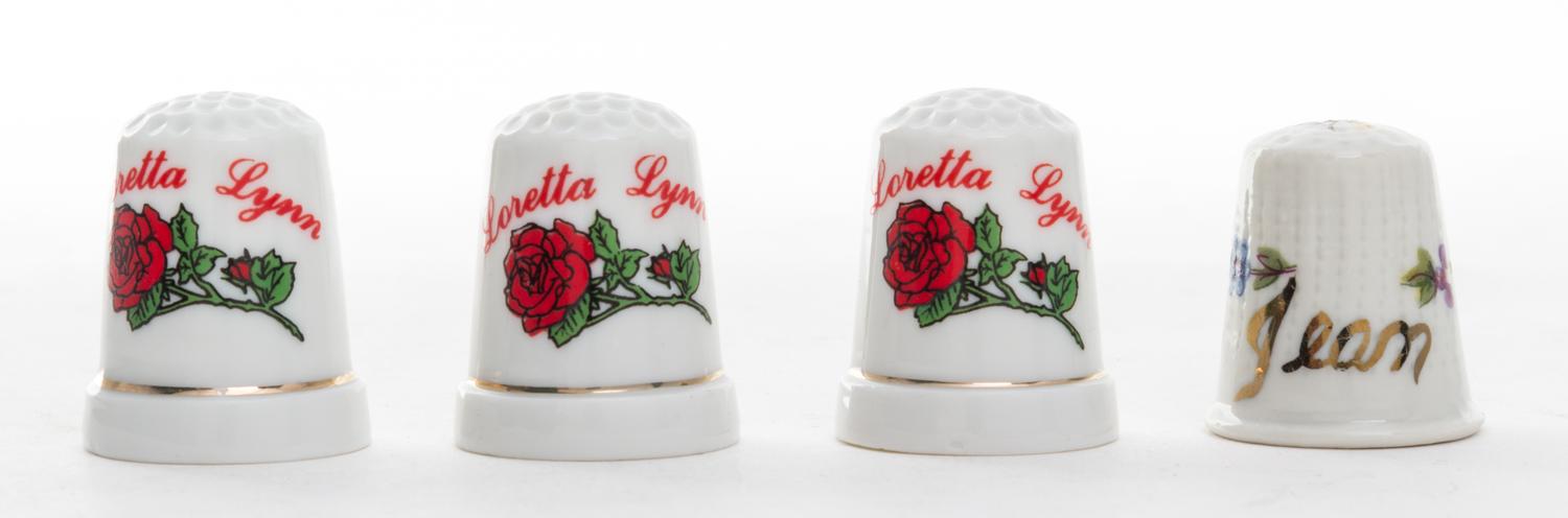A Group of Four Porcelain Personalized Thimbles Height of first 1 1/8 inches.