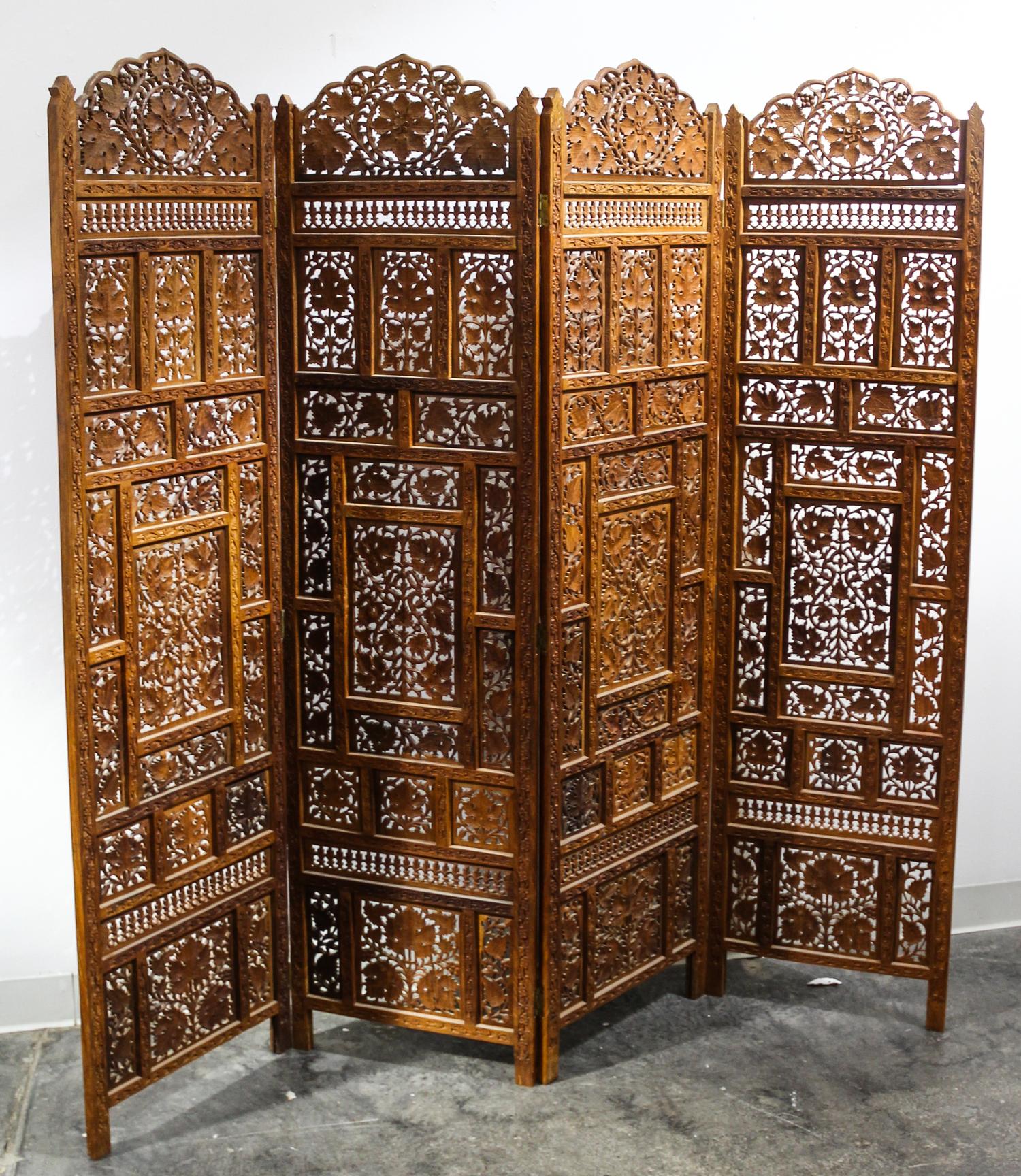 An Indian Four Panel Carved Floor Screen Height 69 x width 17 3/4 inches (each panel). — 19TH/20Th CENTURY