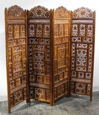 An Indian Four Panel Carved Floor Screen Height 69 x width 17 3/4 inches (each panel). — 19TH/20Th CENTURY