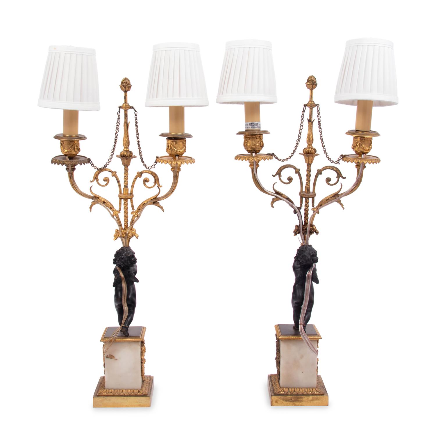 A Pair of French Gilt Metal and Marble Figural Two-Light Candelabra