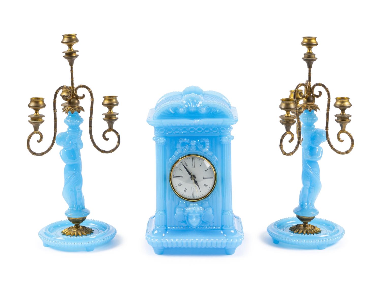 A Continental Blue Opaline Glass Three-Piece Clock Garniture