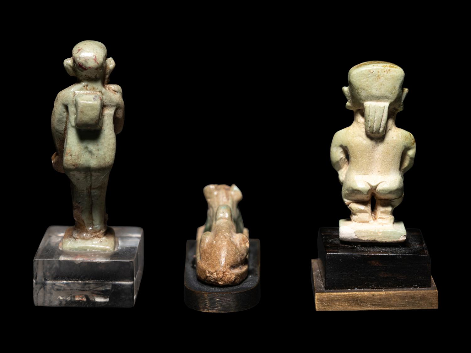 Three Egyptian Faience Amulets Including a Pataikos, a Harpocrates, and a Recumbent Lion
