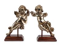 A Pair of Silvered Wood Musical Putto Ornaments