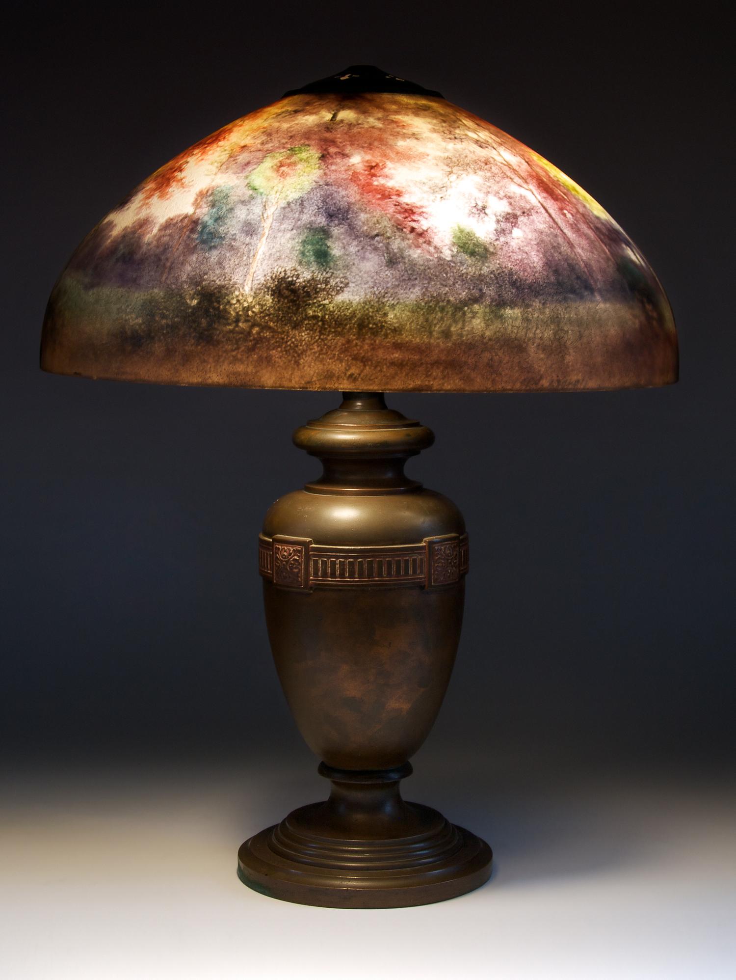 An American Reverse Painted Lamp, Handel, Diameter of shade 18 inches; height of lamp overall 22 1/2 inches.