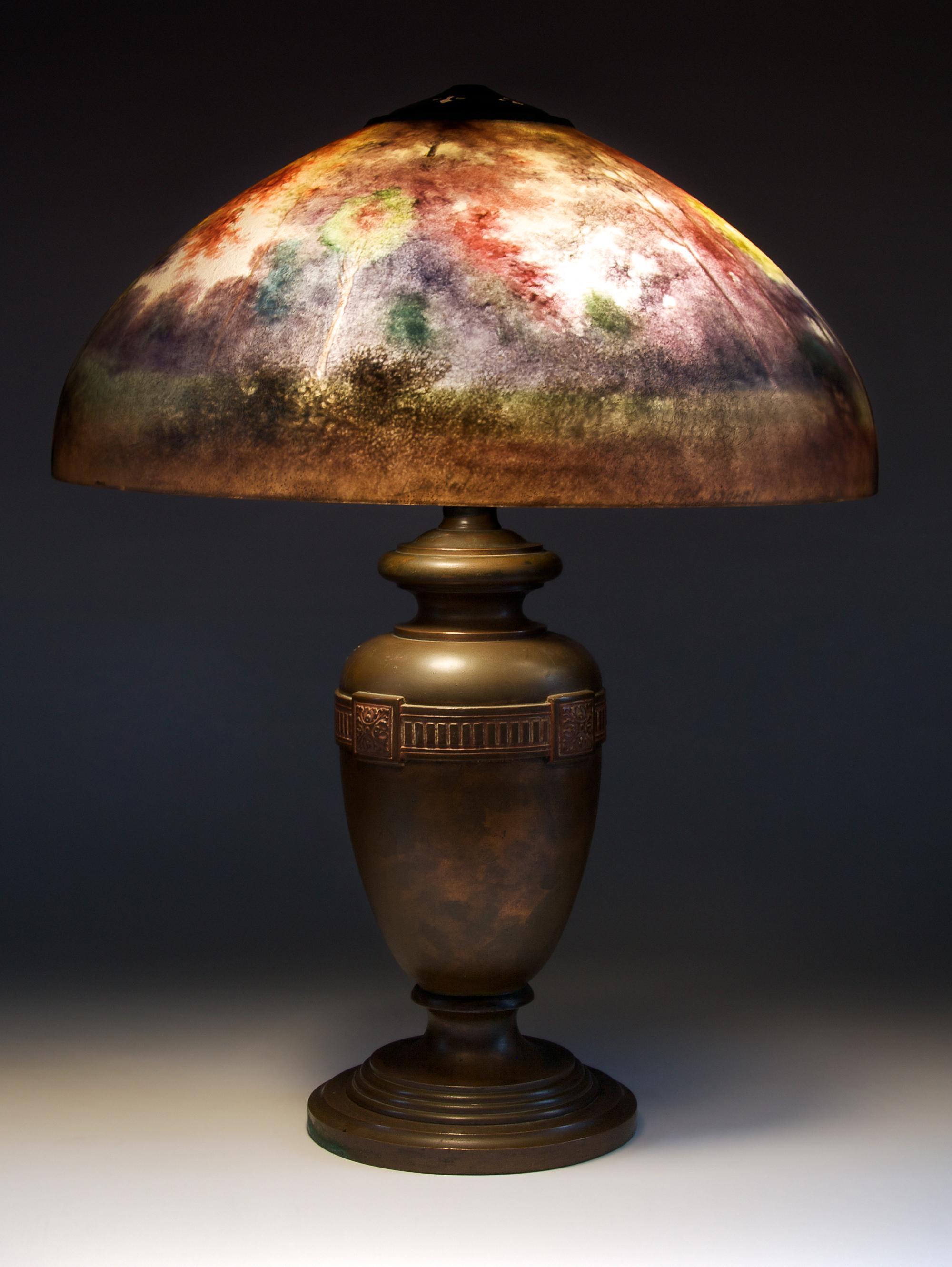 An American Reverse Painted Lamp, Handel, Diameter of shade 18 inches; height of lamp overall 22 1/2 inches.