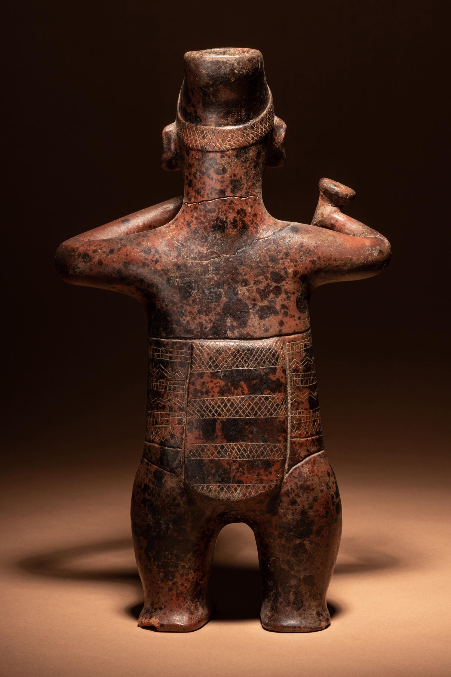 A Colima Terracotta Standing Male Figure with Incised Decoration