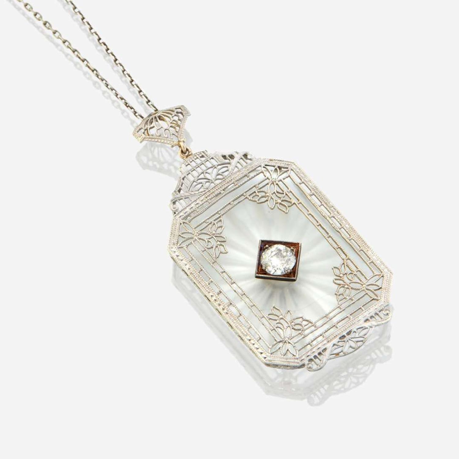 A diamond, rock crystal, and white metal pendant