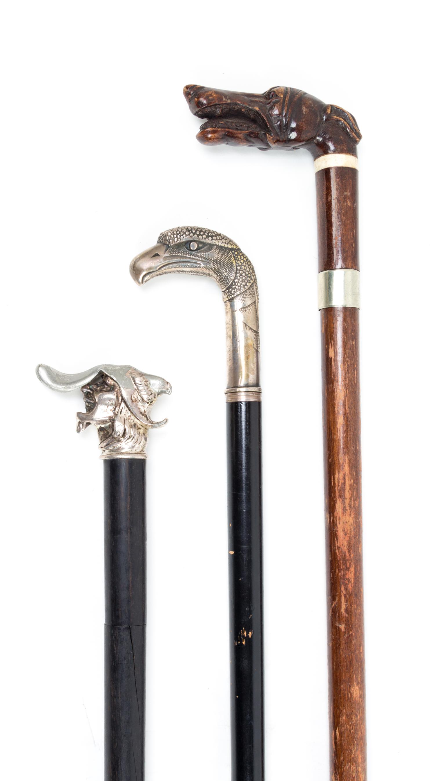 Three Figural Handled Sword Canes Length of longest 37 5/8 inches.