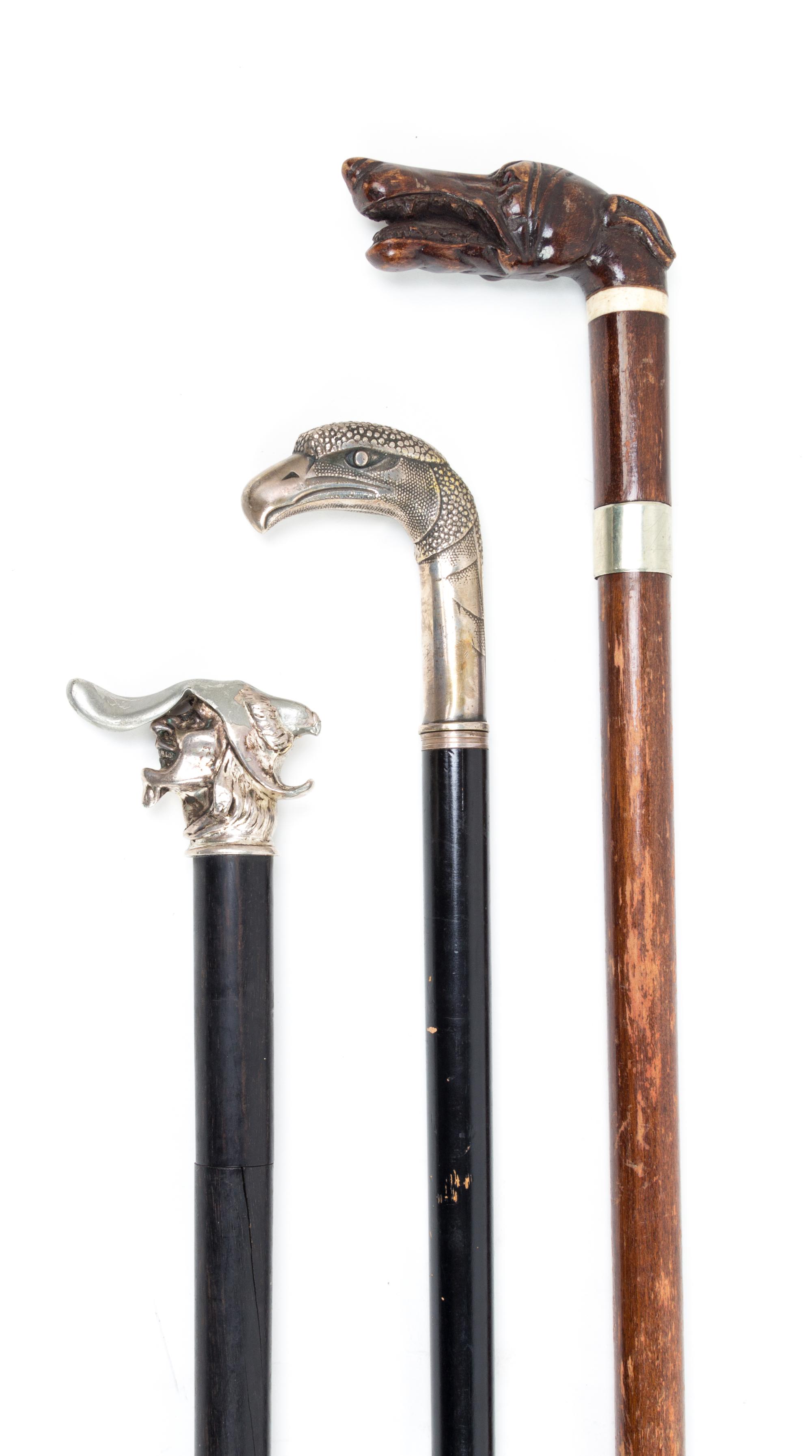 Three Figural Handled Sword Canes Length of longest 37 5/8 inches.