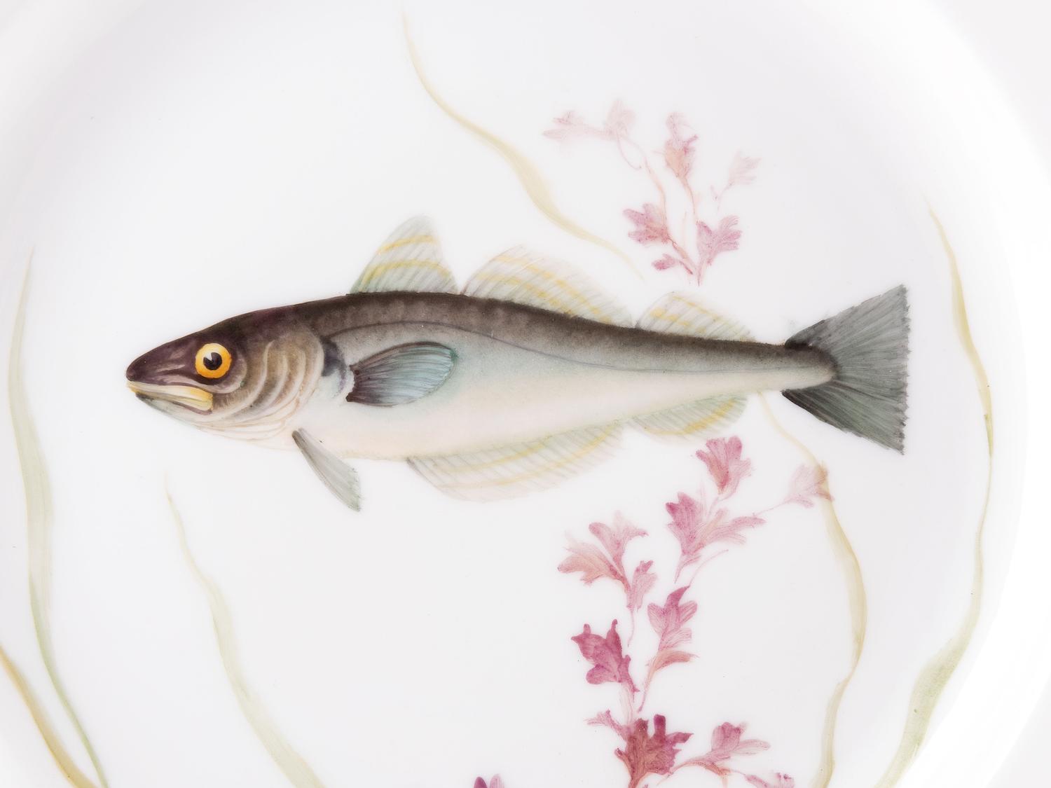 A Set of Twelve Royal Copenhagen Parcel Gilt Porcelain Fish Plates