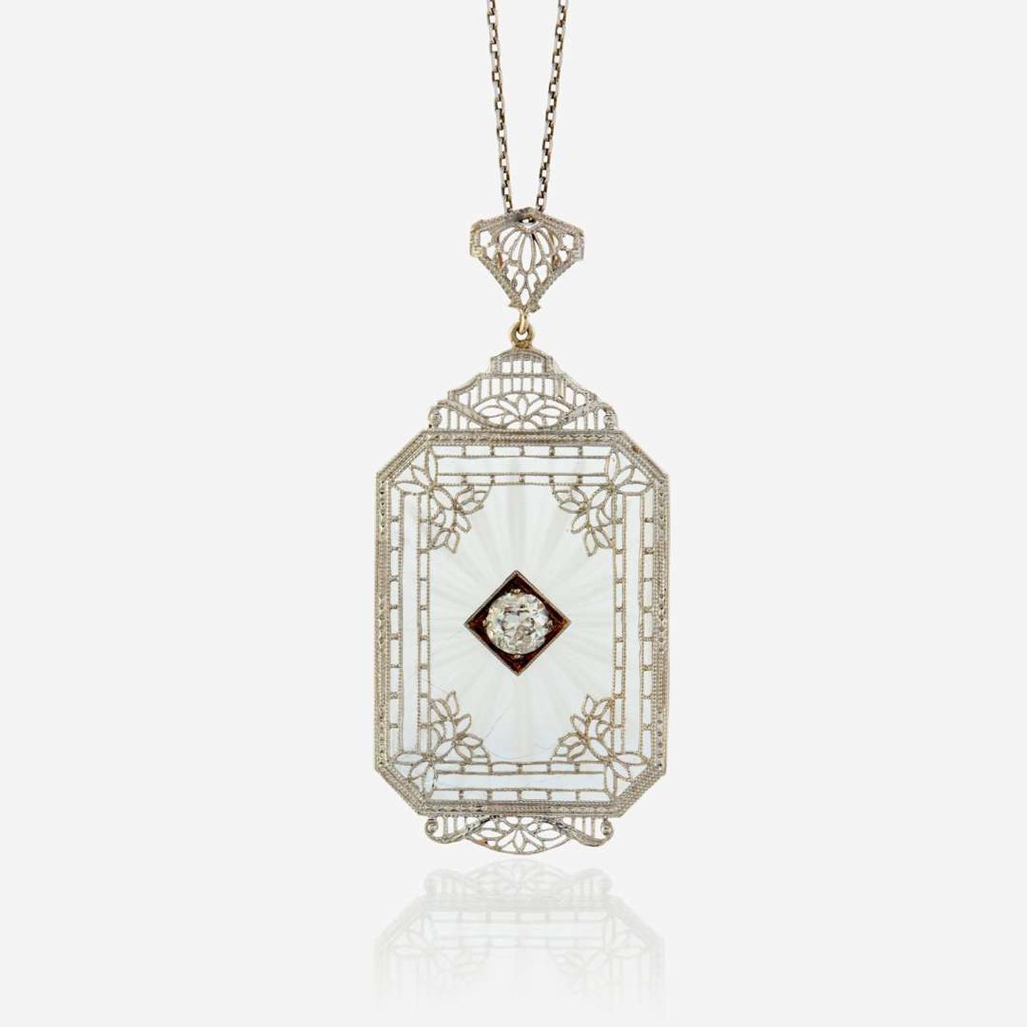 A diamond, rock crystal, and white metal pendant
