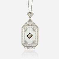 A diamond, rock crystal, and white metal pendant