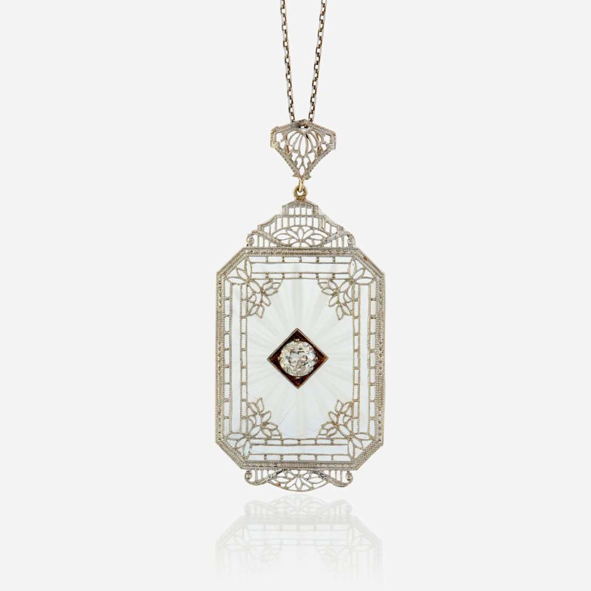 A diamond, rock crystal, and white metal pendant