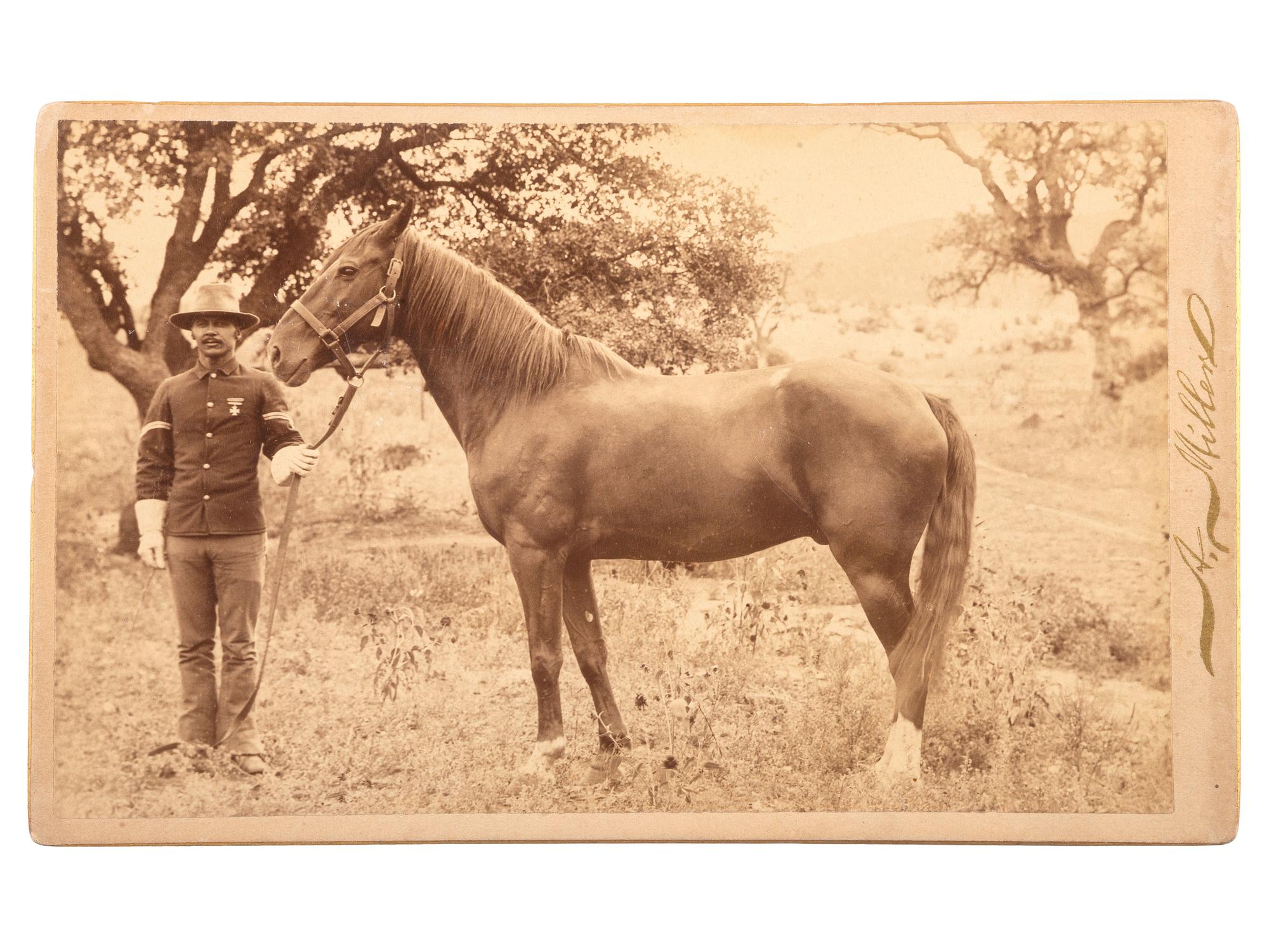 [AFRICAN AMERICANA - LATE INDIAN WARS]. MILLER, Andrew, photographer. Boudoir photograph of a Buffalo Soldier and his steed. [Globe, AZ, or Silver City, NM]. Ca 1890.