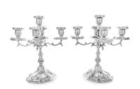 A Pair of Mexican Silver Five-Light Candelabra, Maciel, Mexico City, each having a central urn form candle cup with a lobed drip pan ab