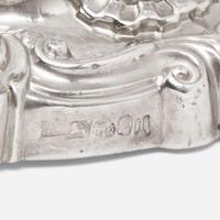Three pairs of George III / Victorian weighted sterling silver candlesticks in the Rococo manner Various makers, Sheffield, dates ranging 1818-1846