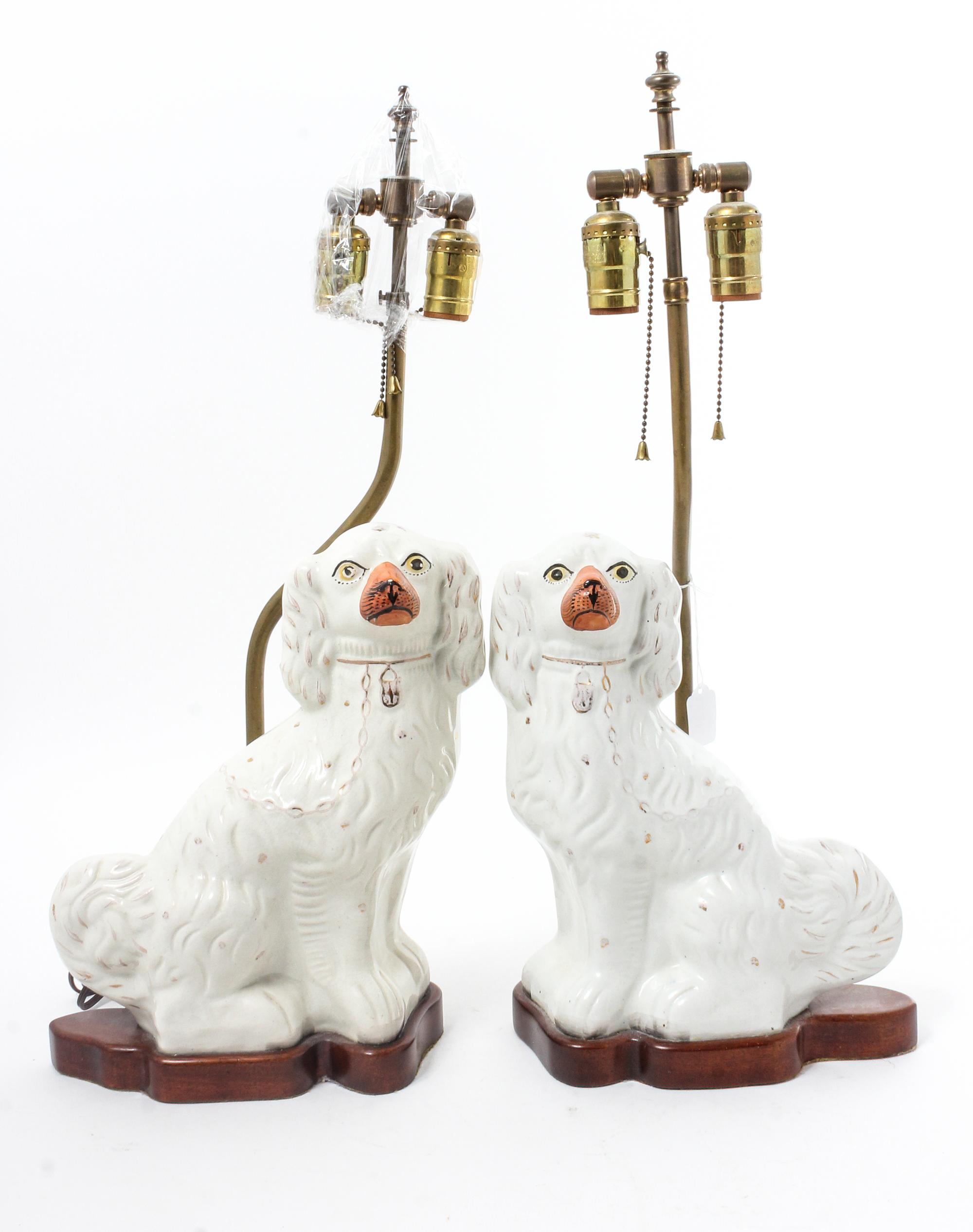 A Pair of Staffordshire Spaniels Height 12 inches. — 19TH CENTURY