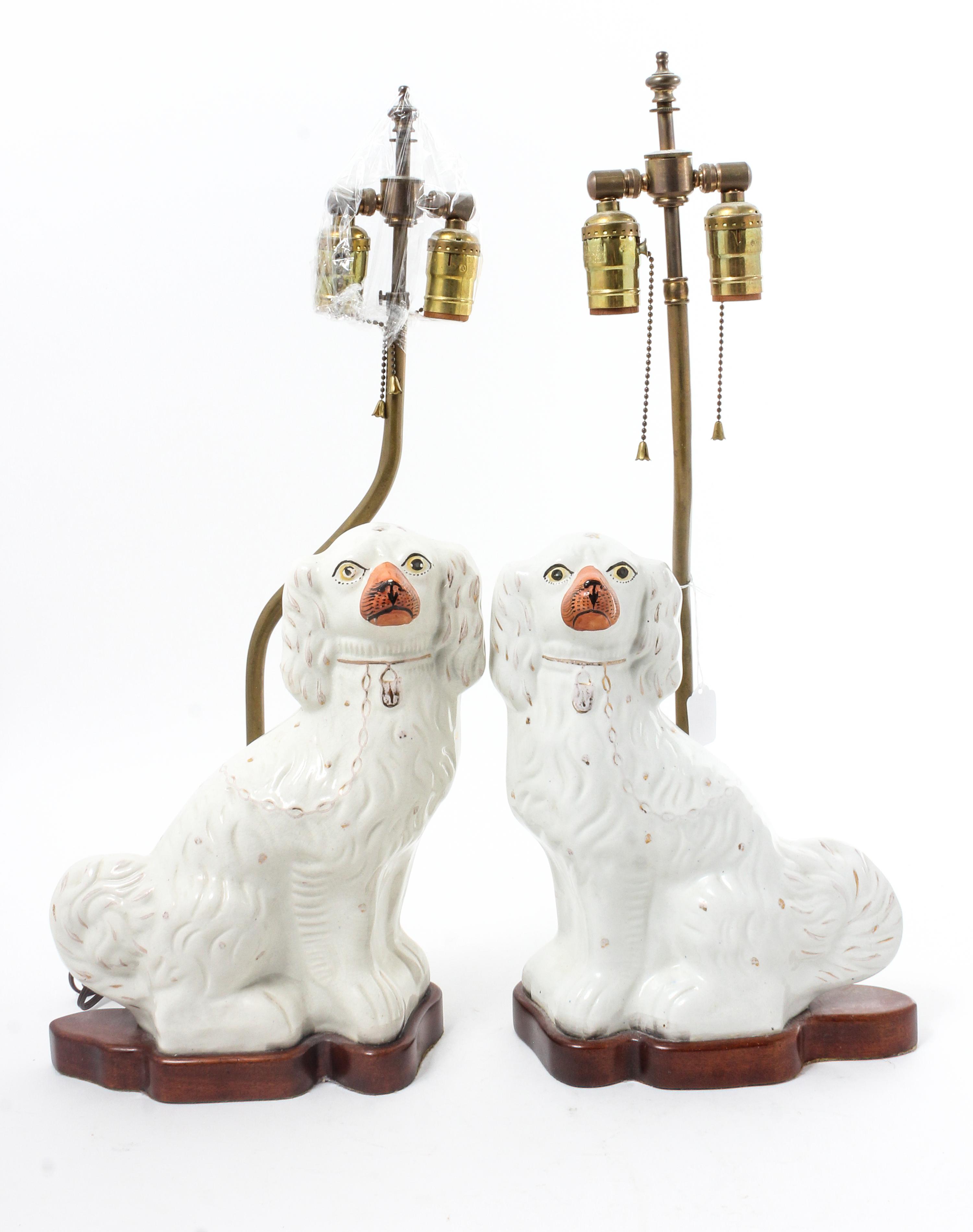 A Pair of Staffordshire Spaniels Height 12 inches. — 19TH CENTURY