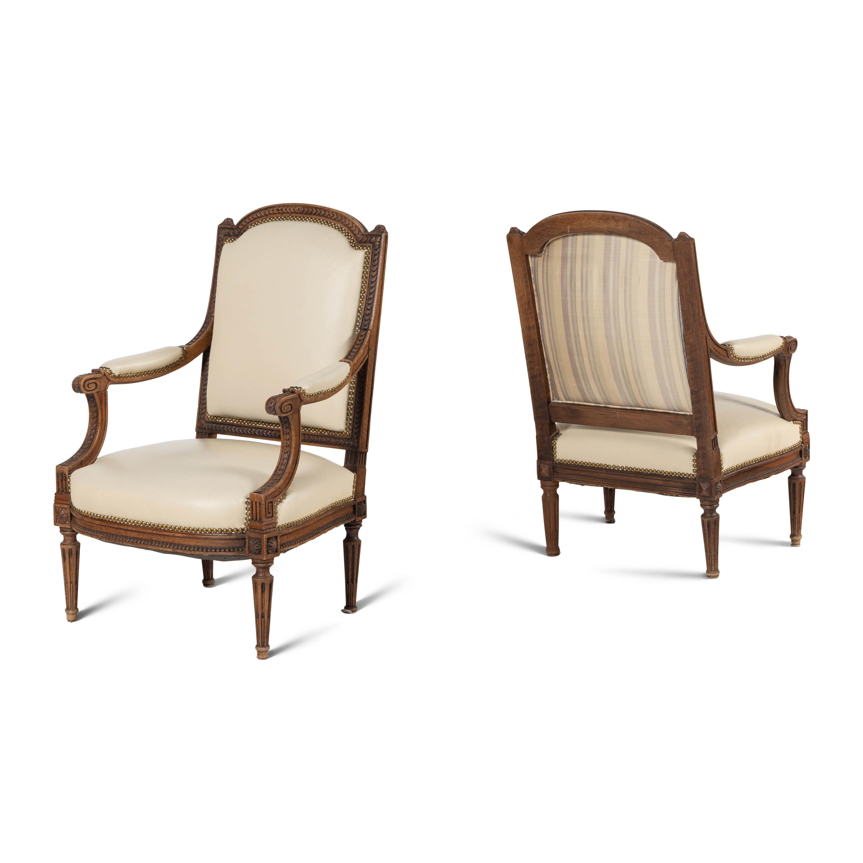 A Pair of Louis XVI Style Walnut Fauteuils