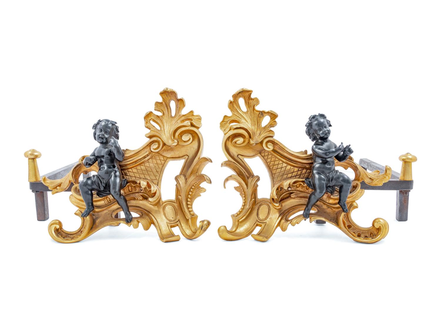 A Pair of French Gilt and Patinated Bronze Figural Chenets and Fender