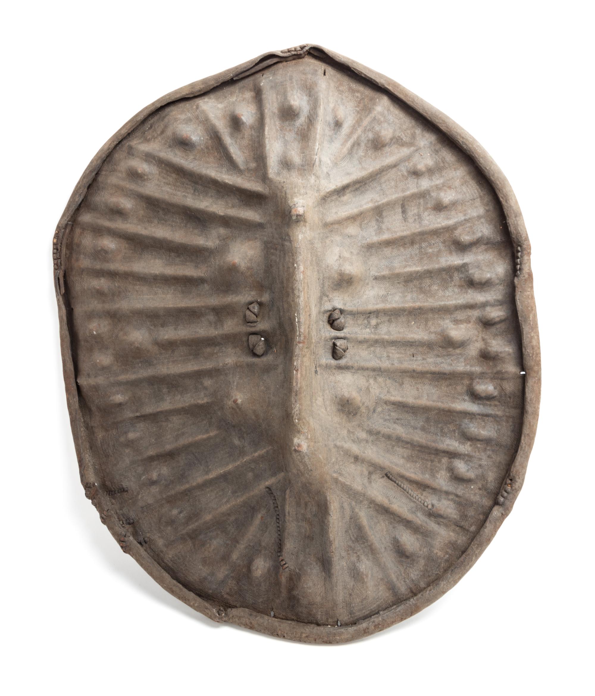 An African Tortoise-Form Leather War Shield, Central Congo. Length 28 3/4 inches.