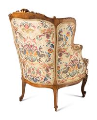 A Pair of Louis XV Style Carved Walnut Bergères