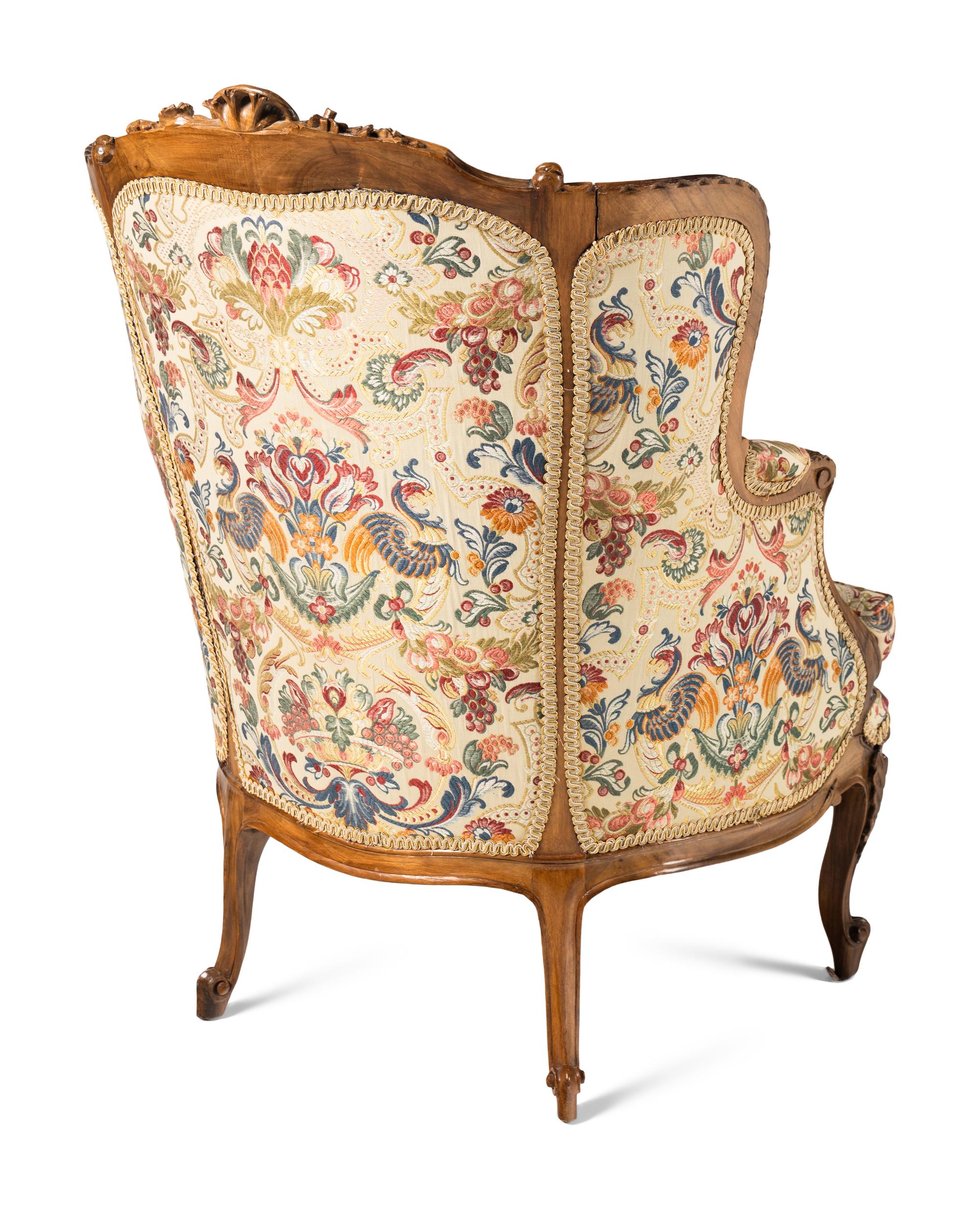 A Pair of Louis XV Style Carved Walnut Bergères