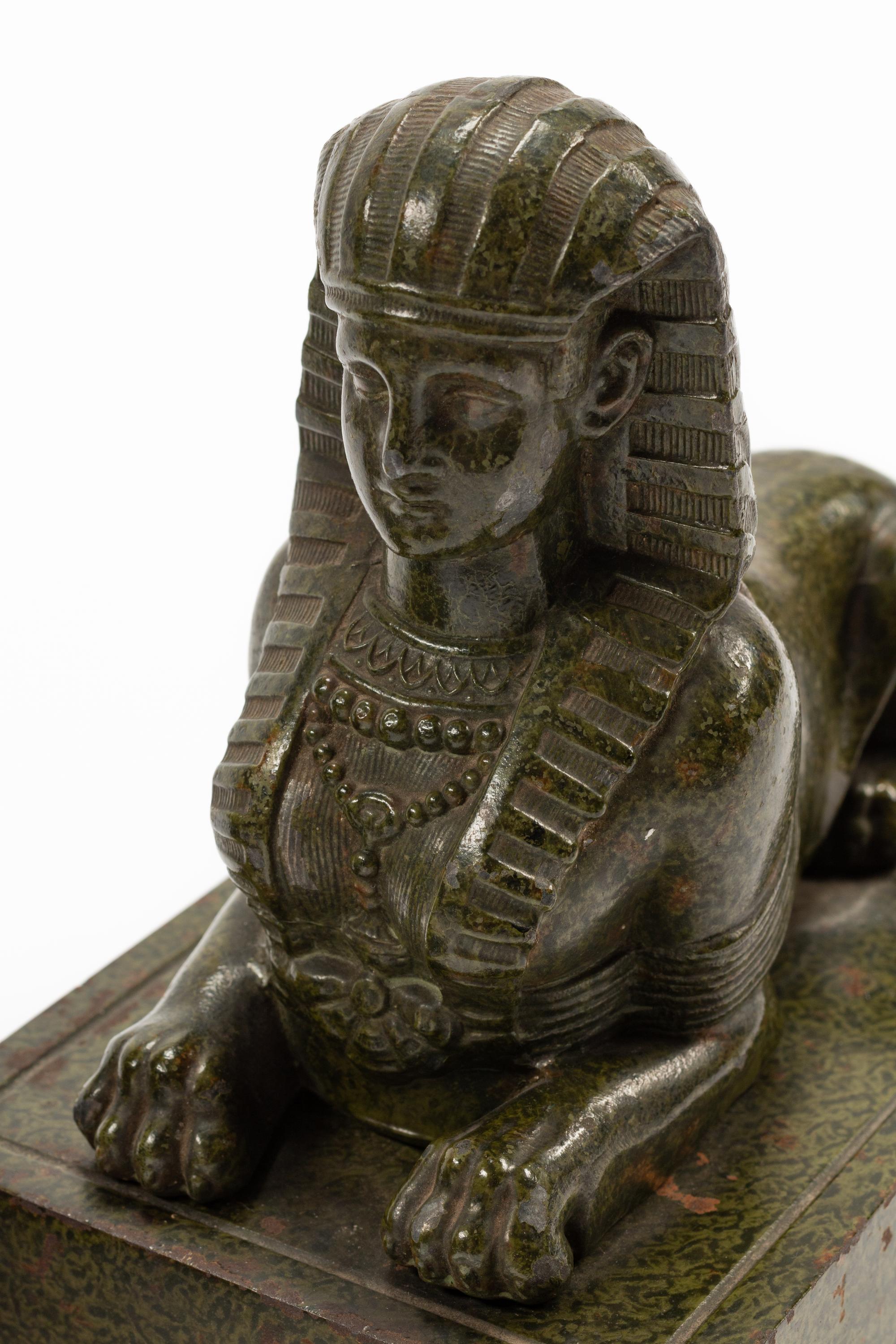 A Pair of Continental Patinated Metal Sphinxes