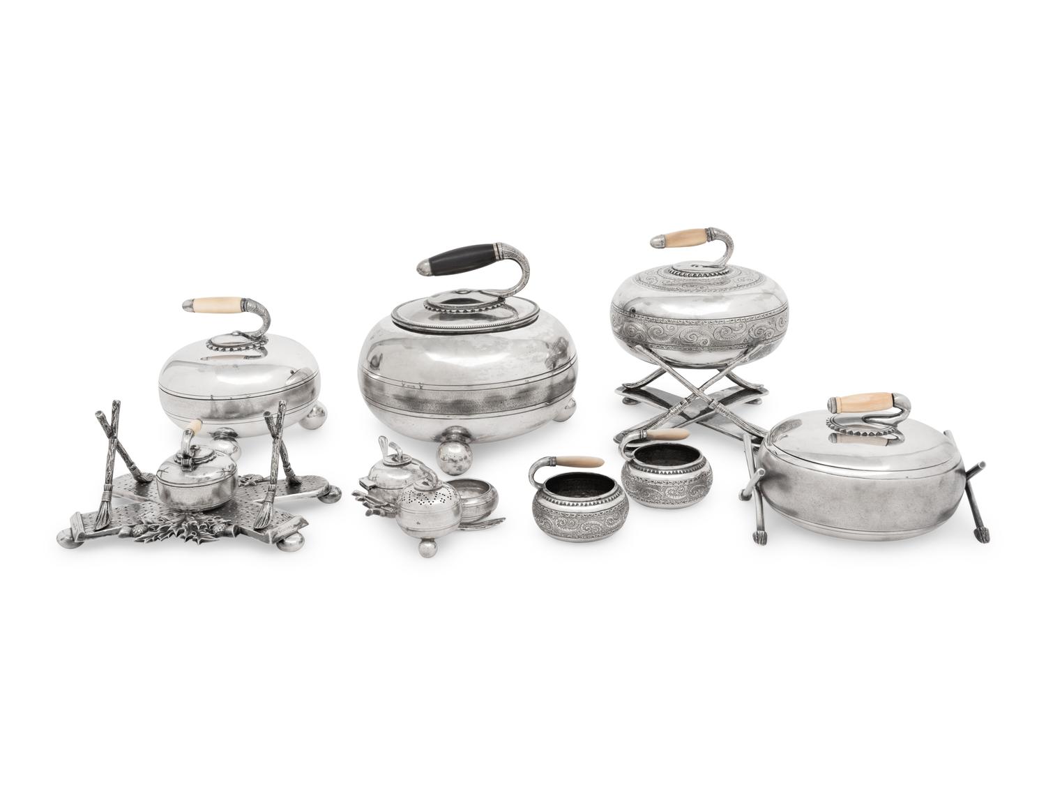 A Group of Eight Curling Stone-Form Silver-Plate Table Articles