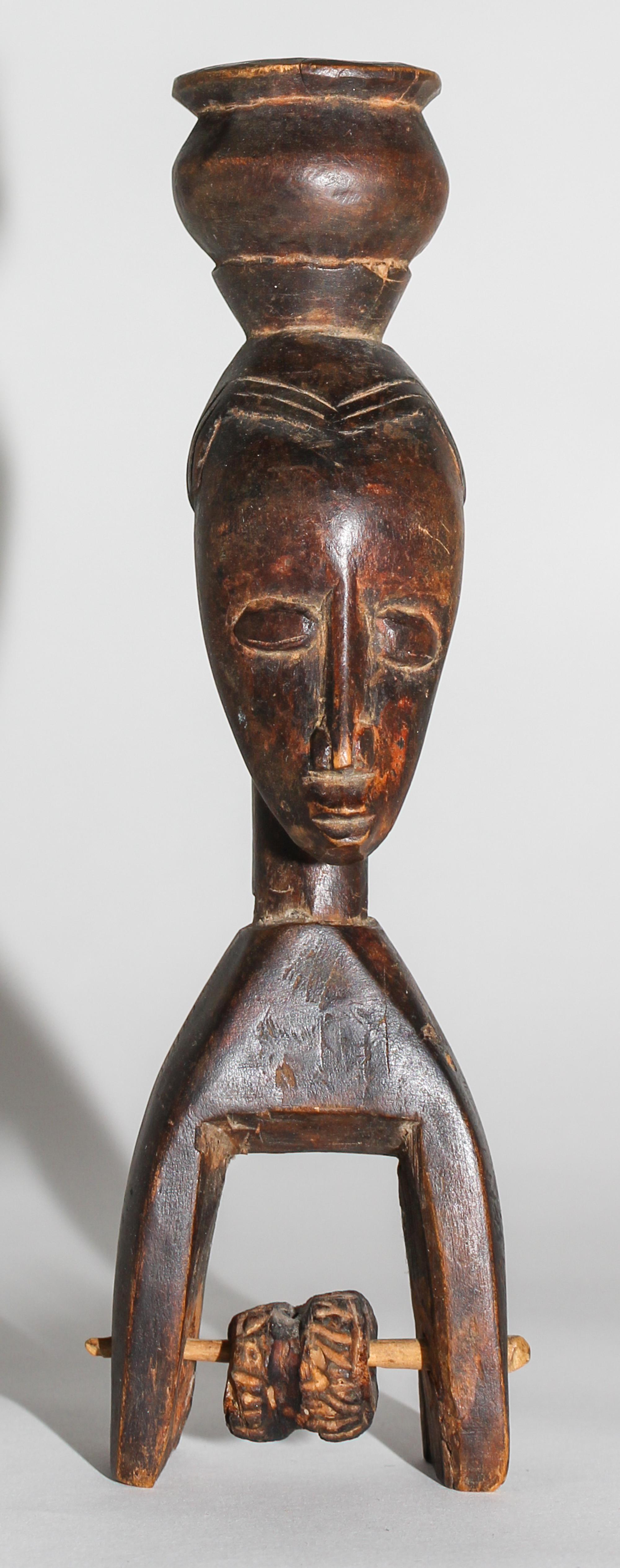 A Senufo Wood Figural Pulley. Height 8 3/4 inches.