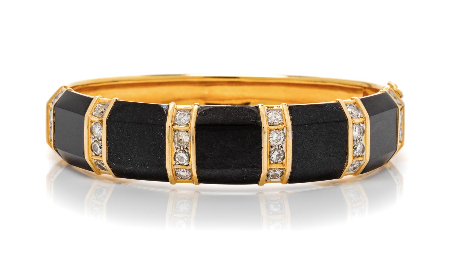 An 18 Karat Yellow Gold, Diamond and Onyx Bangle Bracelet, 35.10 dwts.
