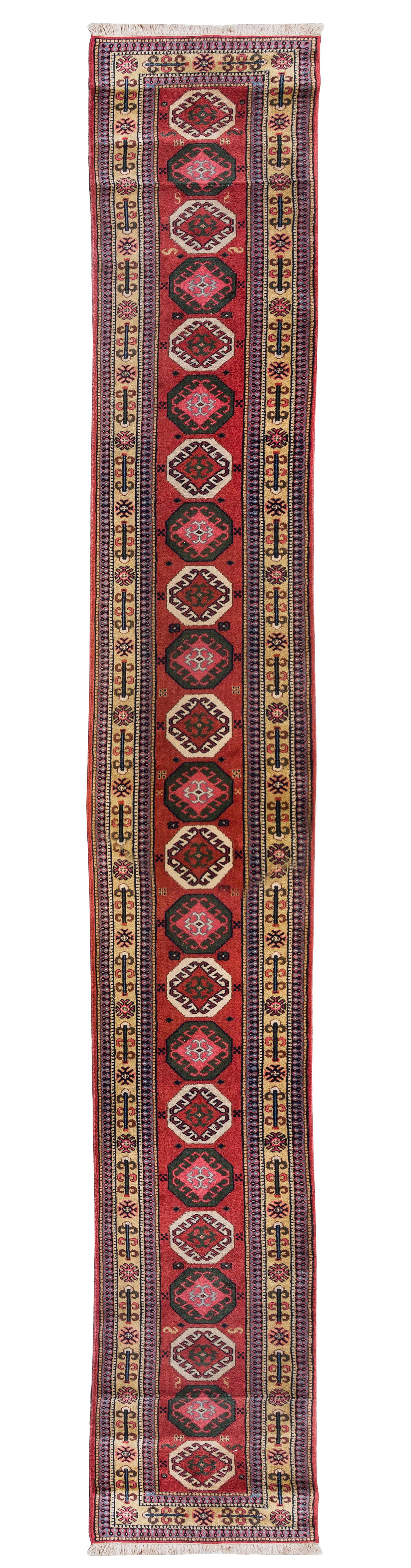 A Caucasian Wool Runner 20 feet 3/4 inches x 2 feet 7 inches.