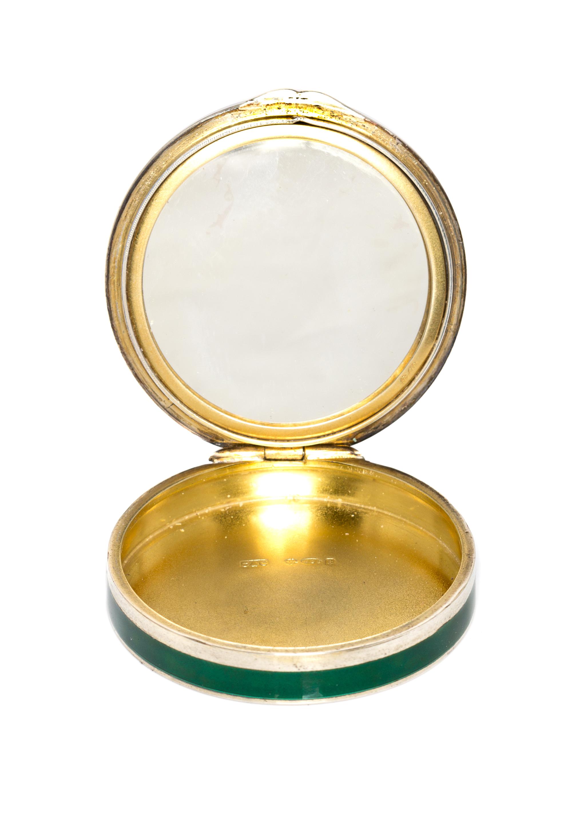 A Continental Silver and Enamel Compact, Import Mark C&C, London, 1925, of circular form, the lid with gilt and red foliate elements on