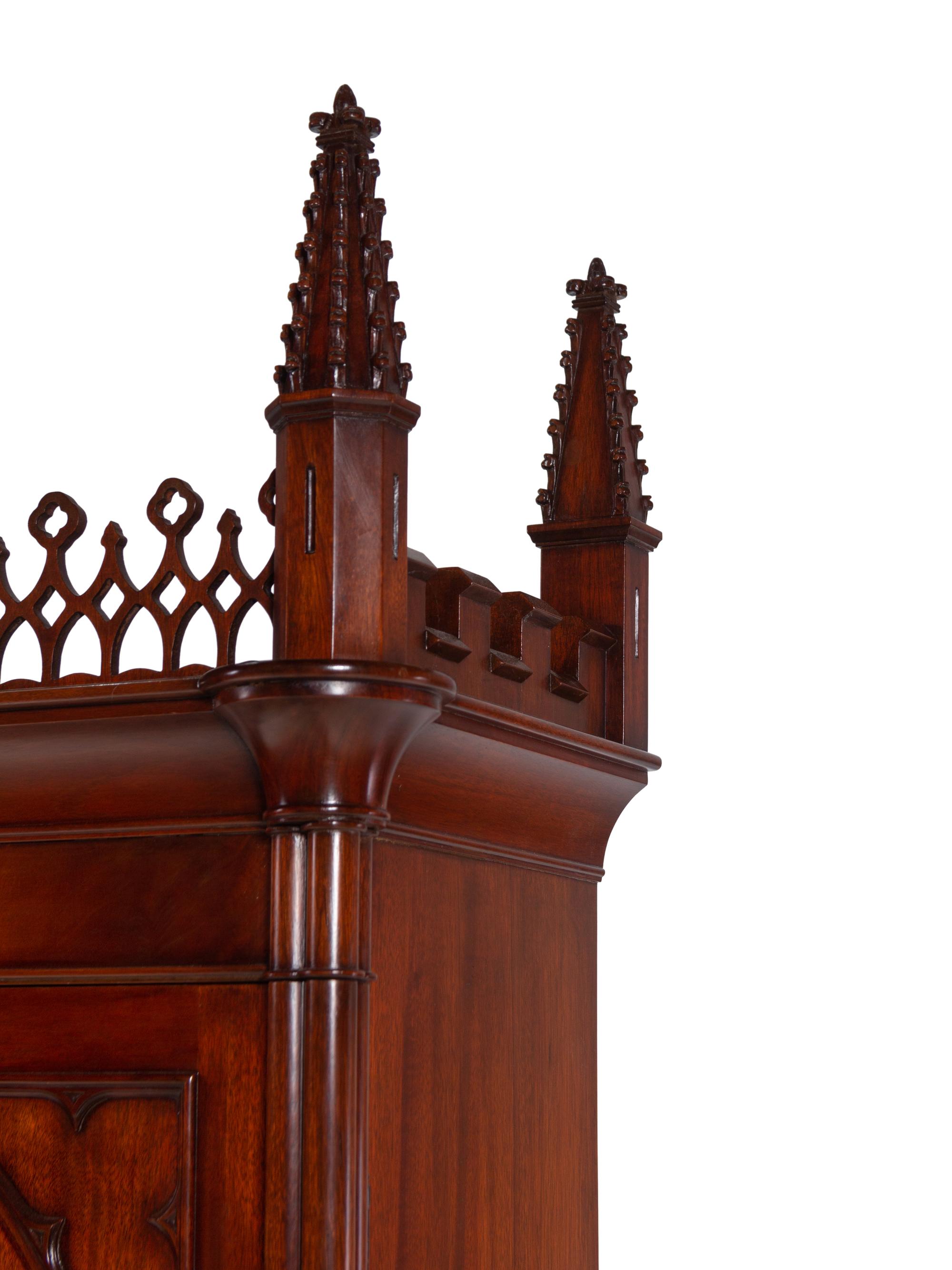 A Gothic Style Carved Mahogany Cabinet with P.E. Guerin Hardware