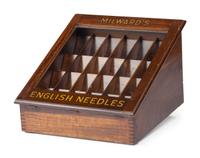 A Milward's English Needles Countertop Display Case