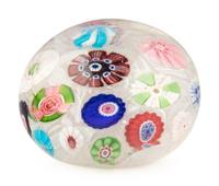 A Clichy Spaced Concentric Millefiori and Rose Cane on Upset Muslin Glass Paperweight