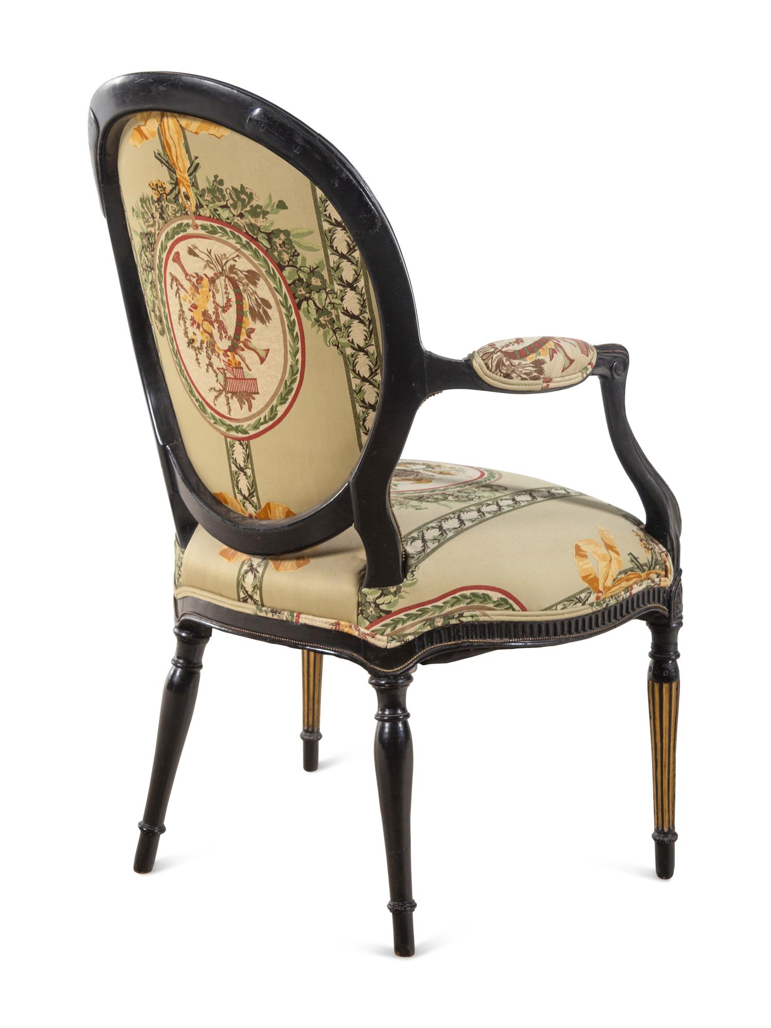 A George III Style Parcel Gilt and Ebonized Armchair