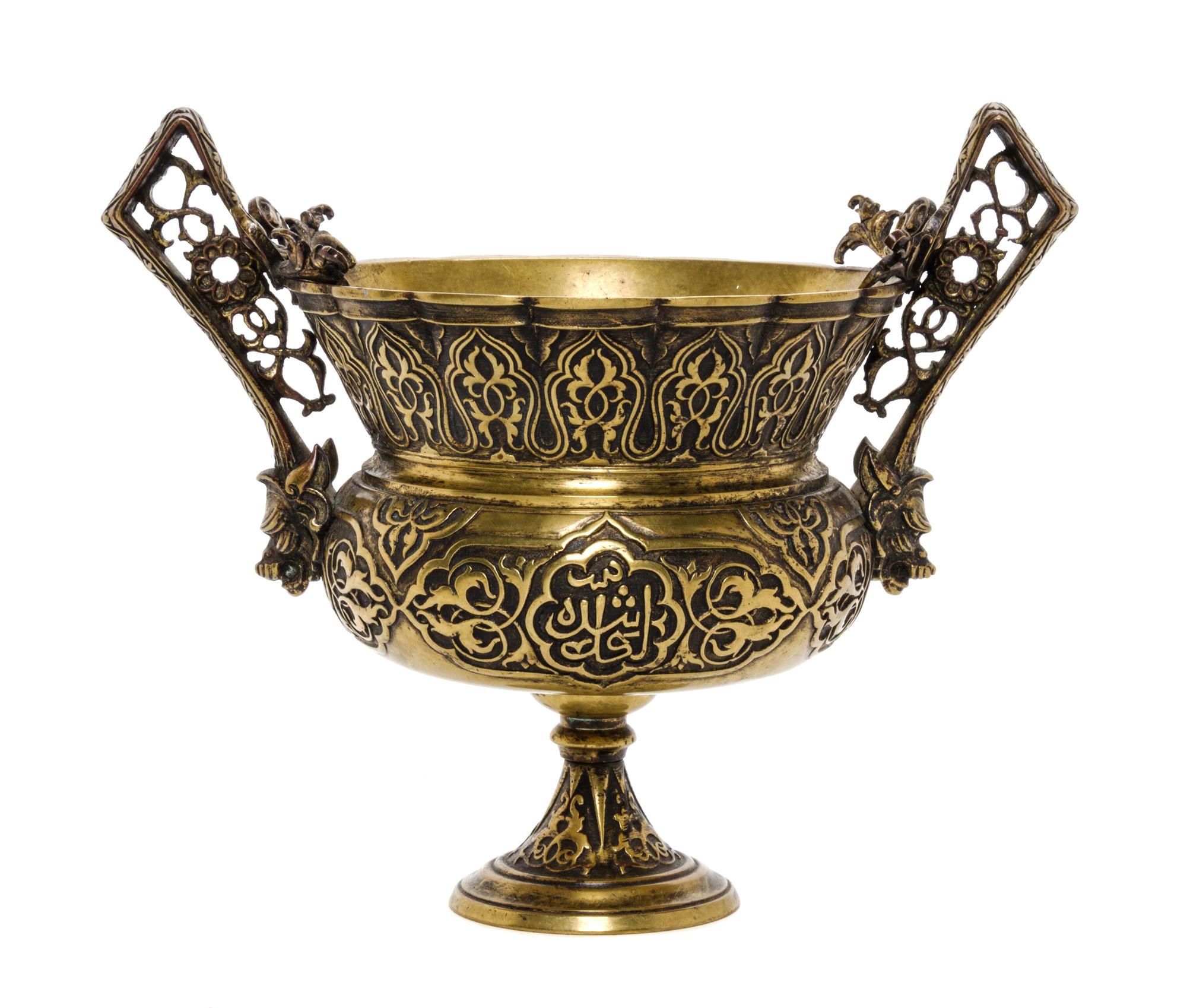A Middle Eastern Bronze Urn, Height 6 inches.