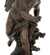 A French Bronze Figure of Eros on a Wood Base