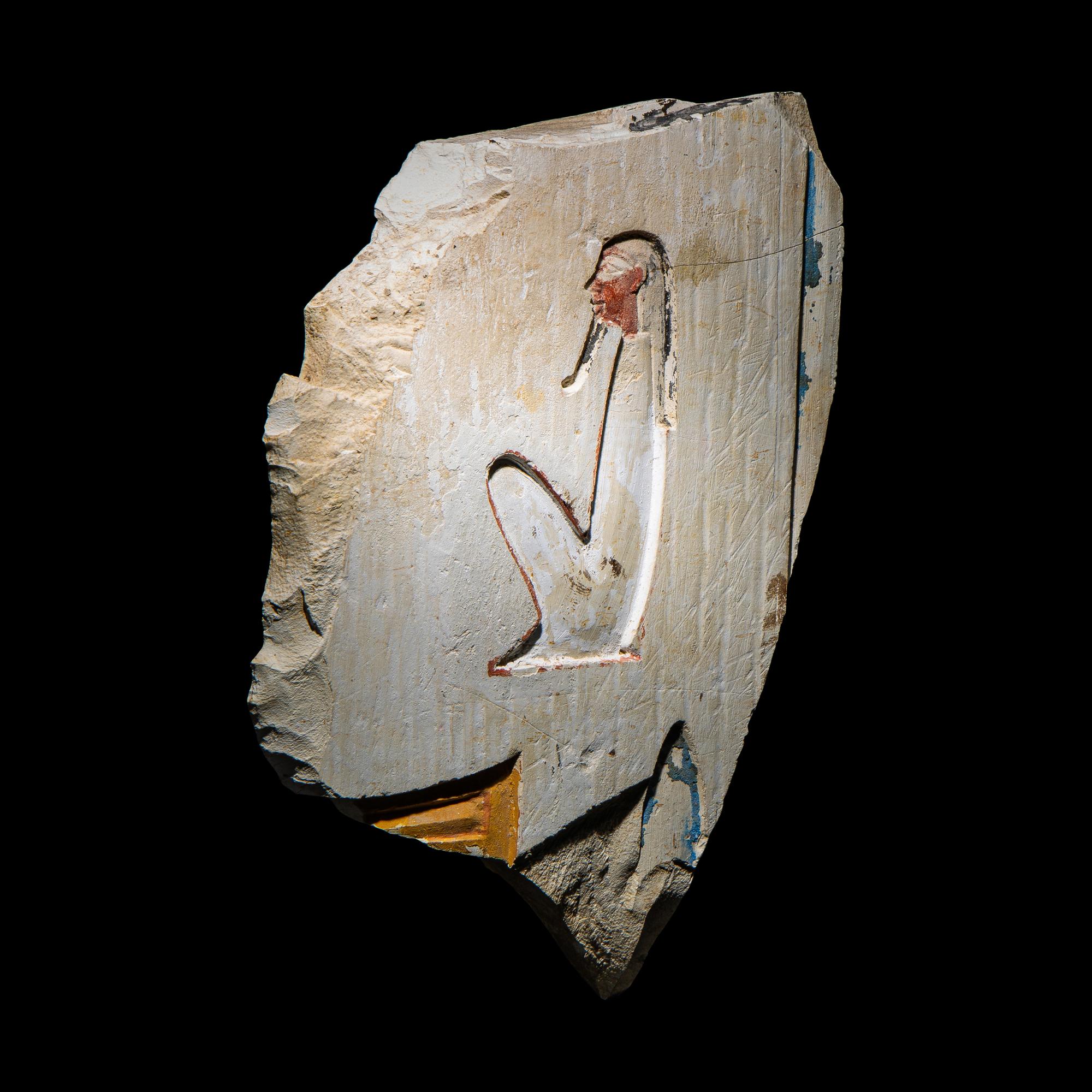 An Egyptian Painted Limestone Relief Fragment