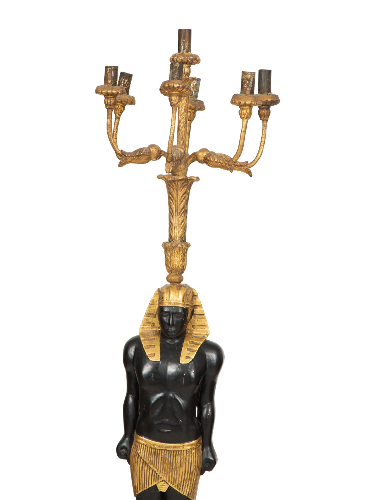A Pair of Egyptian Revival Ebonized and Giltwood Figural Torchères