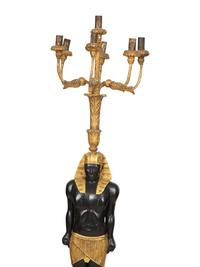 A Pair of Egyptian Revival Ebonized and Giltwood Figural Torchères