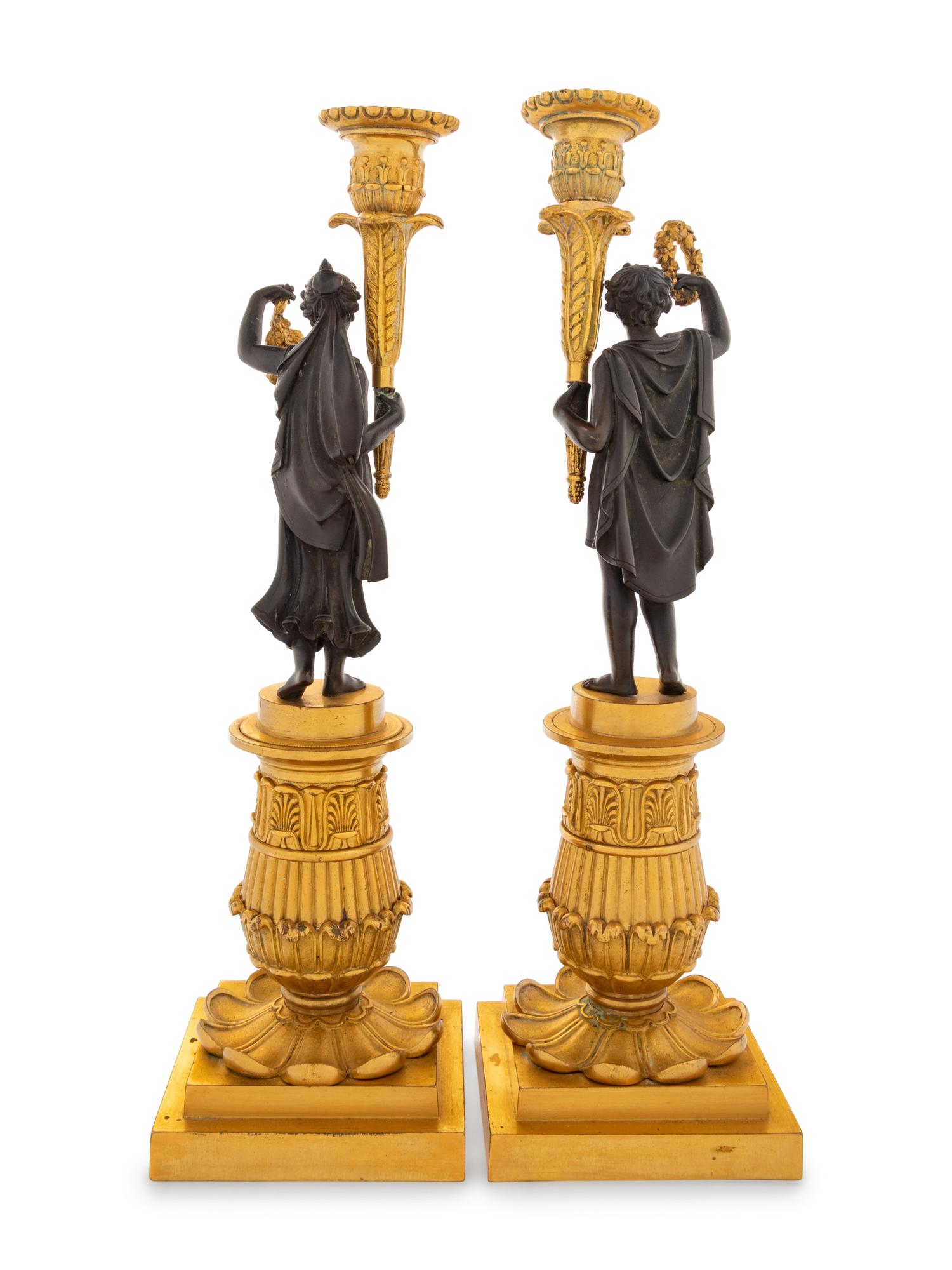 A Pair of Charles X Style Gilt and Patinated Bronze Figural Candlesticks